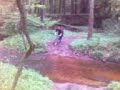 dude trying to cross a river on a bicycle