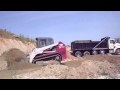 Loading a quad with the Takeuchi TL 150 Skid Steer