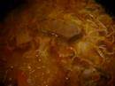 dutch oven simmering gulasch soup, hungary-born soup, with pasta, favorable for such a cold snow-falling day as today!