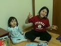 Sudona helps Avya with her sticker book Sudona helps Avya with her sticker book