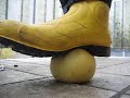 Rubber boots with steel toes crushing water melon Rubber boots with steel toes crushing water melon