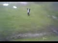 kid going down mud hill in a bin