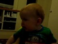 Elliott giggling at the pink flower