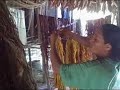 Angela hangs recently dyed chambira on the side of her porch.