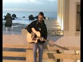 mick hart devant la plage de biarritz jouant en acoustic le titre 