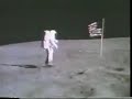 the television camera mounted on the lunar rover records the astronauts photographing each other beside the flag. duke appears first, getting into position beyond the flag. young walks into view and does a 