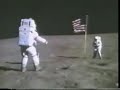 the television camera mounted on the lunar rover records the astronauts photographing each other beside the flag. duke appears first, getting into position beyond the flag. young walks into view and does a 