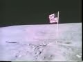 the television camera mounted on the lunar rover records the astronauts photographing each other beside the flag. duke appears first, getting into position beyond the flag. young walks into view and does a 