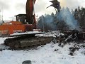 dad operating a hitachi ex200 stocking burn pile