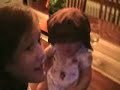 bailey singing to her little sister cameron while she stands on the dining room table.