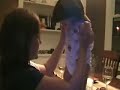 bailey singing to her little sister cameron while she stands on the dining room table.