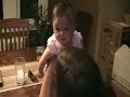 bailey singing to her little sister cameron while she stands on the dining room table.