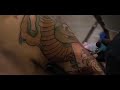 Lizard getting lizard tattoo by Rodney Raines
