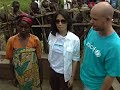 unicef ambassador lucy liu shows residents of a camp for internally displaced people in the dr congo that a unicef-supplied water source is safe for drinking.