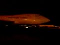 747 departing  glasgow storm at night