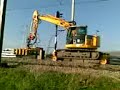 Komatsu PC 138 US met dwarsligger uitlegtang