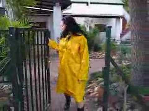 Rainweargirl - Rainweargirl on the farm wearing a yellow PVC rain smock. This smock is the same length as a raincoat and made from slippery PVC with a rubbery feel on the o...