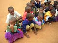 children sitting outside of school - all copying one boy children sitting outside of school - all copying one boy