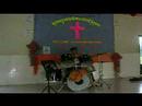Joel Ng playing drums in Cambodian village church
