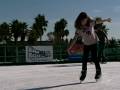 in spite of the warm climate, new technological advancements now enable outdoor ice rinks to be built in southern california.  sandra hughes straps on her skates for a test run.