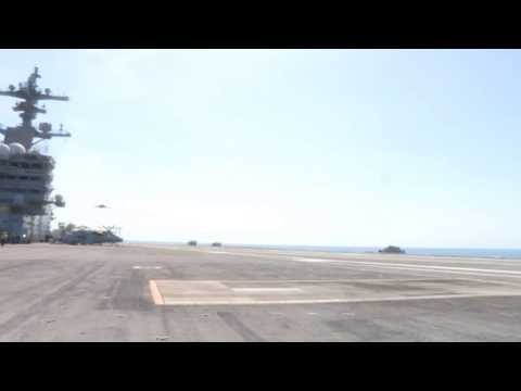 Touch - An X-47B Unmanned Combat Air System (UCAS) demonstrator conducts a touch and go landing on the flight deck of the aircraft carrier USS George H.W. Bush (CVN ...