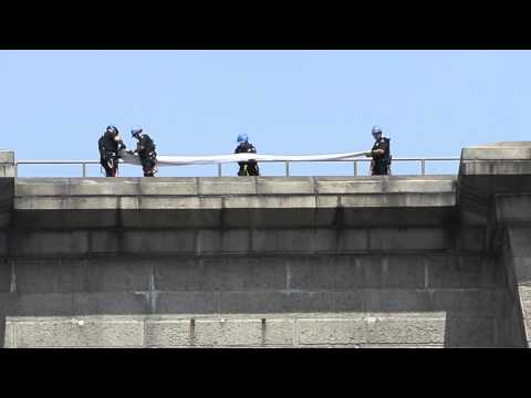 bridge - Emergency Services cops lowered the two rogue flags — which are the traditional symbol for