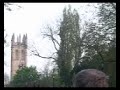 the magadalen college boys choir singing their traditional madrigals (or whatever) at the top the college tower, seen from the other side of magdalen bridge, shortly after sunrise  on 1 may 2005 in oxford.