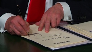 Trump, fond of signing executive orders, awaits more pens