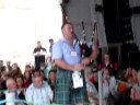 mark mckenzie participating in the kitchen piping competition at lorient during the festival interceltique.  he has help from 2 delightful young girls who dance and provide him with fuel when he slows down