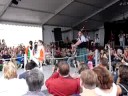 mark mckenzie participating in the kitchen piping competition at lorient during the festival interceltique.  he has help from 2 delightful young girls who dance and provide him with fuel when he slows down