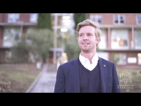 close up of Angus Balcombe wearing blue sweater and blazer