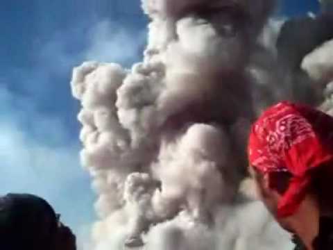 「火山がまさに噴火してる目の前で記念撮影をするご一行。」のイメージ