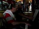 jos� pedro rosales, jazzpianist and owner of the lovely caf� 'conde de barajas' playing with a guest, antonio ximenez 'how do you keep the music playing?' 
pedro is still wearing his cooking-cloth because he prepares delicious dinners in his caf�-restaurant, but when he's got the chance, he sits down at his piano to play along with his many musical customers...

'la vida como la musica: en vivo' (jp rosales)