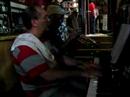 jos� pedro rosales, jazzpianist and owner of the lovely caf� 'conde de barajas' playing with a guest, antonio ximenez 'how do you keep the music playing?' 
pedro is still wearing his cooking-cloth because he prepares delicious dinners in his caf�-restaurant, but when he's got the chance, he sits down at his piano to play along with his many musical customers...

'la vida como la musica: en vivo' (jp rosales)