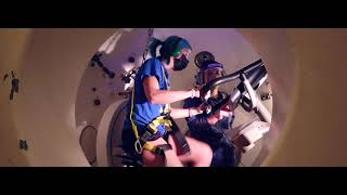 Student observes as senior research support specialist, rides a stationary bike in the Center for Research and Education in Special Environments’ hyper/hypobaric chamber.