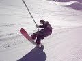 Snowboarder pulls a manual on ski lift Snowboarder pulls a manual on ski lift