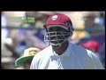 colin miller sports dyed blue hair against the west indies in a cricket match.courtney walsh cannot contain his laughter!