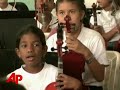 plusinspiring venezuela's children a note at a timeinspiring venezuela's children a note at a timethe associated pressvenezuela has become a hotbed of young classical music talent thanks to a system the country has in place that lets youth of all backgrounds get their hands on precious instruments.  (june 25)[notes:wide shot of street/c/u of building]here along a nondescript street in a nondescript building music is being made.(pause for nat sound)[notes:children in classroom]they are the children of venezuela, and like generations before them, they are being instructed in the art of classical music.(pause for nat sound)[notes:various of children playing instruments]it's all part of what's known as 