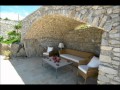 Linear stone house facing the town of Mykonos by ...