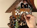 This charming chalet has been a long-time best seller. It has nice proportions and is beautifully colored. The dancers are animated, as well as the baby deer below. With each cuckoo call they are startled and actually jump up. New details in this piece include laser-cut windows and beautifully carved deer. The roof has individually hand-laid shingles, and the dial, hands, and bird are all of solid wood. The waterwheel also turns and there are several fine details on this clock - including a 