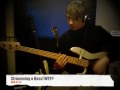 Strumming on a Bass Guitar.