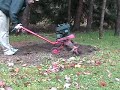 This is a video of some of the engine cleaning I did on my uncle's tiller. My grandfather purchased it brand new in 1958 from sears and it was delivered just before Christmas (off season sale) and used it in his garden. It was later passed down to my uncle who uses it for landscaping.

The video covers me starting the tiller for the first time, finding out the low idle screw was out of adjustment, the needle metering valve was out of adjustment, and me removing the mouse condo.  Not shown are me changing the oil and recommending a new head gasket.

It has been repainted various times and now has a 7 HP Tecumseh engine. The heavier engine and more power are two big advantages. There is also another set of tines that aren't on the machine if you wanted to till wider.