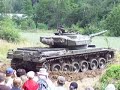 a swiss centurion is filmed driving in the mud during the 2nd military vehicle meeting at th swiss army museum in full-reuenthal, june 10th 2007.