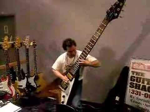 Dude rocks out on a monster sized Flying V guitar.