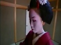 Maiko or geisha being dressed in kimono and other garments