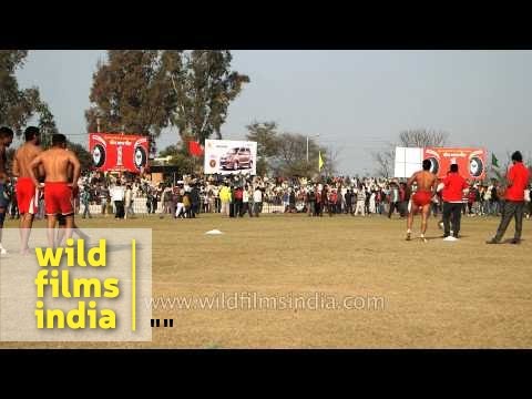Players in full action during a kabaddi match at Kila Raipur, India