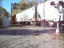 brand new csx es44ac 946 along with c40-8w 7316 (still in conrail blue), sd40-2 8856 and ltex sw1200 3501 (larry's truck and electric, ex bnsf) lead a westbound freight train across south creek road and over ganargua creek near palmyra, ny on 10-11-08. south creek road crossing is located at mp q346.25 on the csx chicago main line.