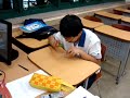 Korean student drumming with pencils