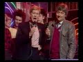 a slice of a typical thursday evening on bbc1, from 26 january 1984: the end of an edition of tomorrow's world (kieran prendiville presenting a demonstration of a sequencer run from a sinclair spectrum, band then plays out with their version of theme tune); trailer for saturday superstore (thompson twins); bbc1 globe; beginning of top of the pops presented by richard skinner and mike smith (first ever totp appearances by madonna and cyndi lauper later in the show, but not in this clip), and beginning of the alarm performing 'where were you hiding when the storm broke?'