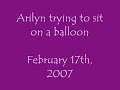 arilyn trying to sit on a balloon